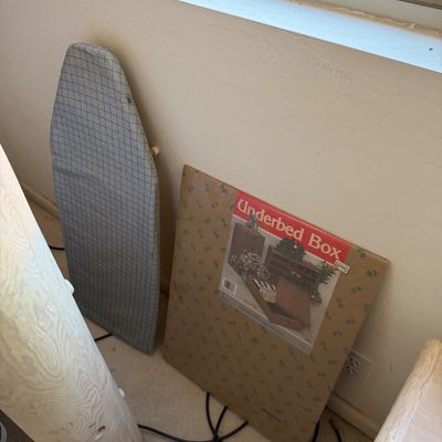 Sale Photo Thumbnail #189: Vintage underbed storage box in its original packaging, shown next to a compact ironing board with a grey grid cover.