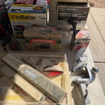 Assortment of tools and outdoor gear including a Lazerpro laser level kit, a vintage Sears Craftsman 3/8-inch drill, an American Camper...