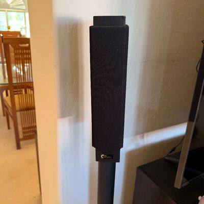Sale Photo Thumbnail #293: Ohm Acoustics floor-standing speaker with a black fabric grille and integrated stand.
