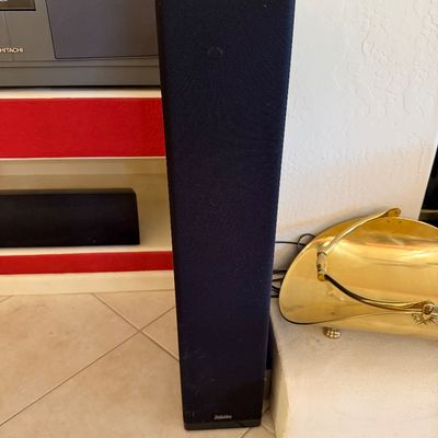 Sale Photo Thumbnail #278: Definitive Technology floor-standing tower speaker with a black fabric grille and glossy top cap.