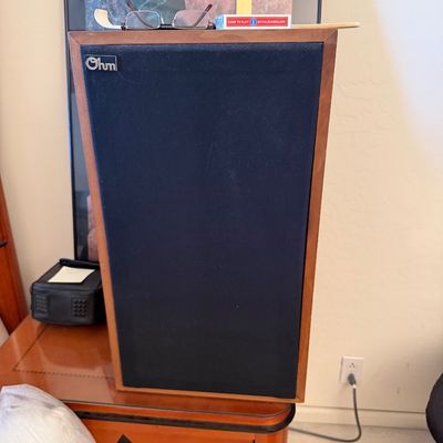 Sale Photo Thumbnail #142: Vintage Ohm floor-standing speaker featuring a wood veneer cabinet and a dark blue fabric grille.