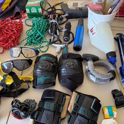 Assorted sporting goods and household items, including Blade Runner knee pads, Rollerblade wrist guards, swim goggles, a bicycle lock,...