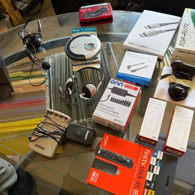 Assorted electronics and accessories, including an Amazon Fire TV Stick 4K Max, an onn. 65W laptop charging adapter, a Philips portable...