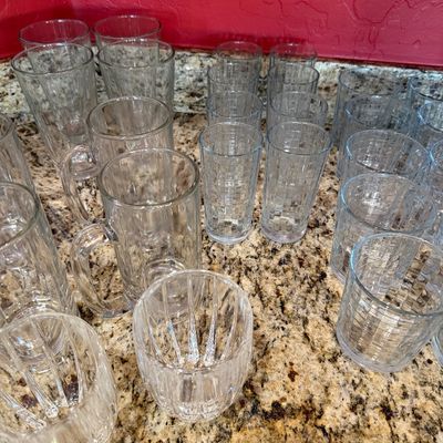Sale Photo Thumbnail #211: Assortment of vintage clear glassware, including heavy beer mugs, textured tumblers, and ribbed lowball glasses.