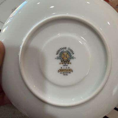 Sale Photo Thumbnail #207: Underside of a Noritake China saucer in the Mayfair pattern (number 6109), showing the maker's mark and design patent information.