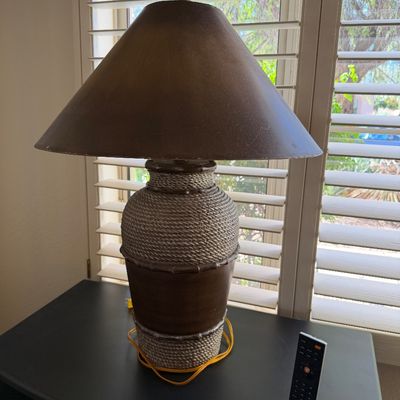 Sale Photo Thumbnail #313: Nautical-style table lamp featuring a rope-wrapped urn base with bamboo-style accents and a matching brown conical shade.