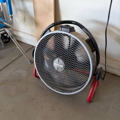 Sale Photo Thumbnail #108: Patton high-velocity industrial floor fan with a black carrying handle and red tubular steel stand.