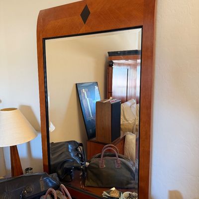 Sale Photo Thumbnail #143: Large contemporary wood-framed wall mirror featuring a curved top with a central diamond inlay detail.
