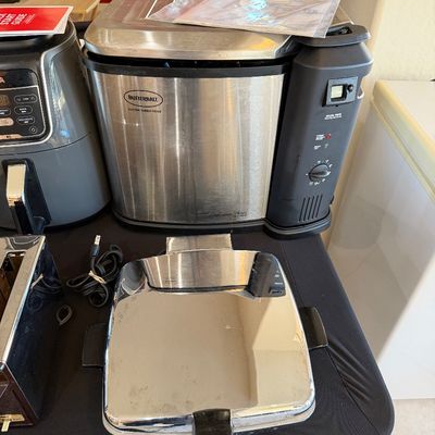 Sale Photo Thumbnail #256: Butterball electric turkey fryer by Masterbuilt, shown alongside a waffle maker and an air fryer on a display table.