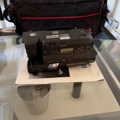 Vintage Sony Handycam Video Hi8 CCD-TRV66 camcorder with user manual and a black padded carrying bag.