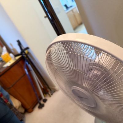 Modern white plastic oscillating pedestal fan, shown in clean, working condition.