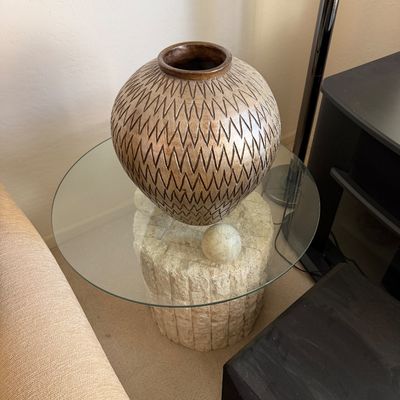 Sale Photo Thumbnail #319: Large ceramic vase with a textured chevron pattern, displayed on a round glass-top side table with a stone-look pedestal base.
