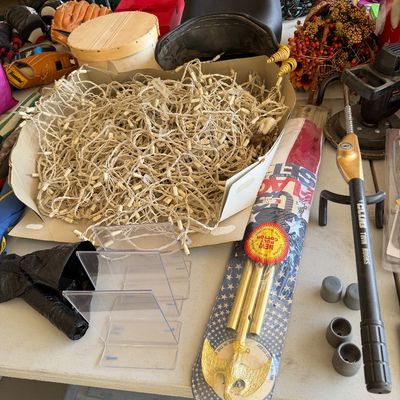 Assorted household and garage items including a large box of white string lights, a packaged US flag set, clear acrylic organizers, and a...