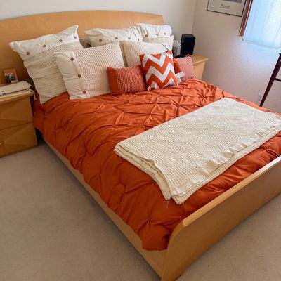 Sale Photo Thumbnail #157: Contemporary light wood platform bed frame with a curved headboard and footboard, styled with an orange pintuck comforter and coordinating accent pillows.