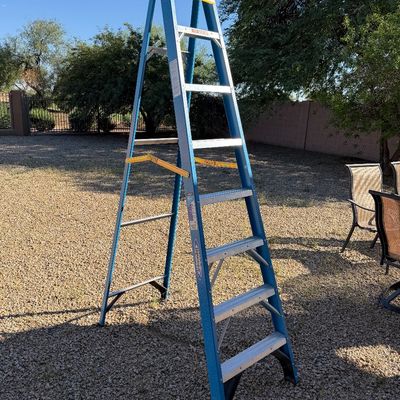 Sale Photo Thumbnail #240: Werner blue fiberglass 8-foot step ladder, showing light wear from use.