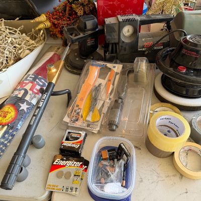 Assortment of garage and household items, including a Campbell Hausfeld 250 PSI air compressor, car buffers, The Club steering wheel...