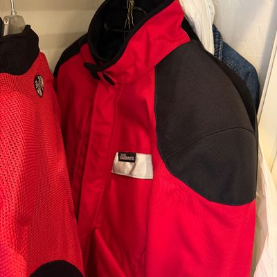 Sale Photo Thumbnail #188: Aerostich Roadcrafter motorcycle jacket in red and black, featuring heavy-duty textile construction and reflective detailing.