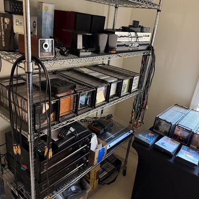 Five-tier wire shelving unit filled with vintage home audio equipment, including receivers, speakers, a turntable, and multiple racks of...