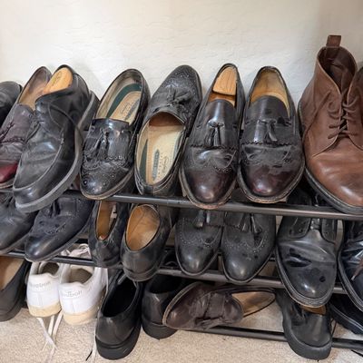 Sale Photo Thumbnail #132: Assorted men's dress shoes, loafers, and boots, including Florsheim Imperial tassel loafers, displayed on a multi-tier shoe rack.