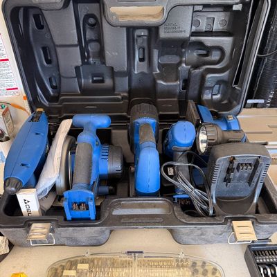 Delta 18V cordless power tool combo kit, including a circular saw, drill, flashlight, and charger, housed in its original black molded...