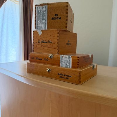 Sale Photo Thumbnail #151: Stack of four vintage wooden Cohiba cigar boxes from Havana, Cuba, featuring various sizes and styles with original labels and branding.
