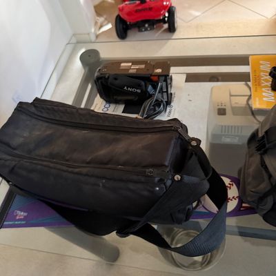 Sony Video 8 Handycam camcorder with a black carrying bag, shown on a glass-top table.