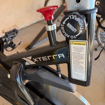 Sale Photo Thumbnail #231: Xterra MB500 indoor stationary cycle, showing the adjustable resistance knob, seat post adjustment, and flywheel.