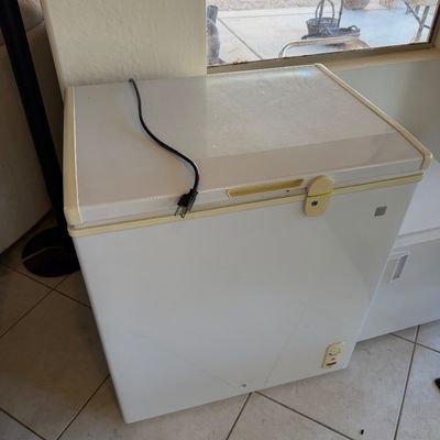 Sale Photo Thumbnail #257: White GE chest freezer with a top-opening lid, showing some light yellowing on the plastic trim.