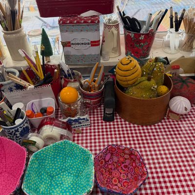 Sale Photo Thumbnail #60: Assorted crafting and sewing supplies, including handmade fabric bowls, felted pin cushions, and various storage containers filled with tools.