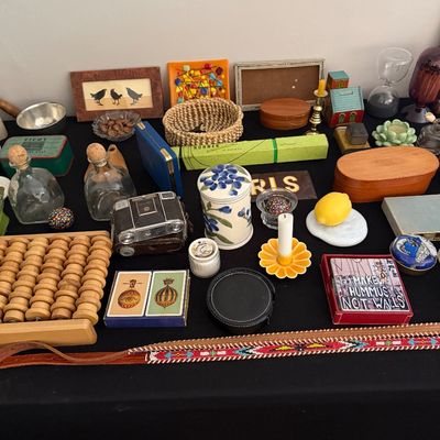 Sale Photo Thumbnail #27: Eclectic assortment of vintage collectibles and home decor, including a wooden abacus, glass decanters, a beaded belt, playing cards, and various small boxes and trinkets.