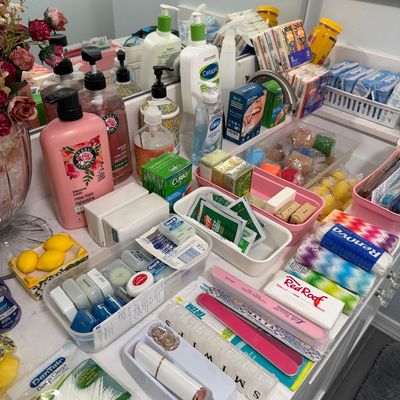 Sale Photo Thumbnail #82: Assortment of personal care and hygiene items, including Herbal Essences shampoo, Cetaphil lotion, dental floss, nail files, and travel-sized toiletries.