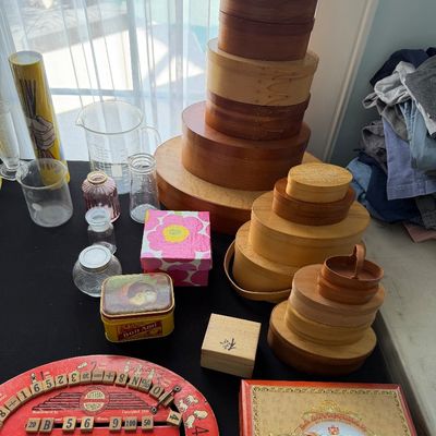 Sale Photo Thumbnail #86: Assortment of vintage items including several stacks of wooden shaker boxes, a vintage red spelling and number board, glassware, and small decorative tins.