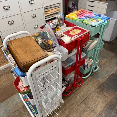 Sale Photo Thumbnail #61: Three rolling utility carts in white, red, and mint green, filled with various craft supplies including acrylic paints, embroidery floss, and storage containers.
