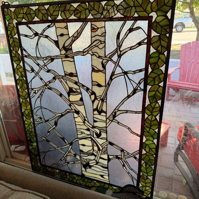 Sale Photo Thumbnail #69: Stained glass window panel depicting birch trees with a green leaf border, featuring hanging loops on the top corners.
