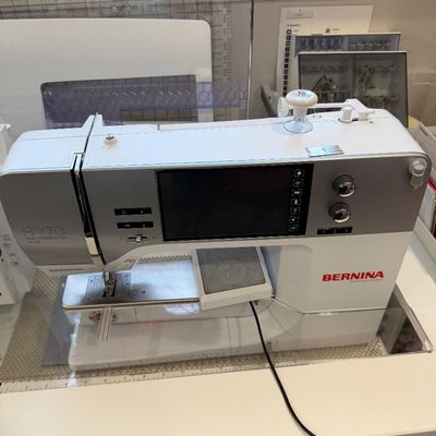 Sale Photo Thumbnail #48: Bernina B 770 QE (Quilters Edition) Plus sewing machine, featuring a digital touchscreen display and modern white and silver housing.