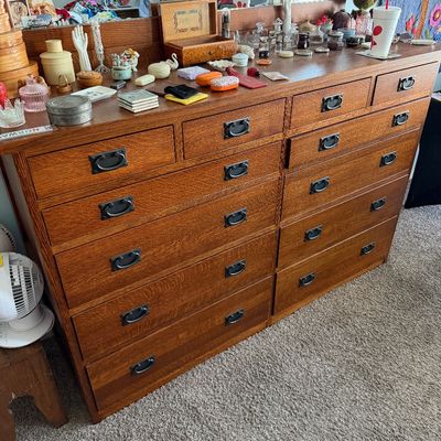 Sale Photo Thumbnail #94: Large Mission-style quarter-sawn oak dresser featuring a double column of drawers with dark metal bail pulls and a matching attached mirror.