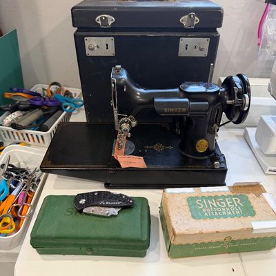 Sale Photo Thumbnail #52: Vintage black Singer Featherweight 221 sewing machine with its original black carrying case, a green accessory box, and a boxed Singer buttonhole attachment.