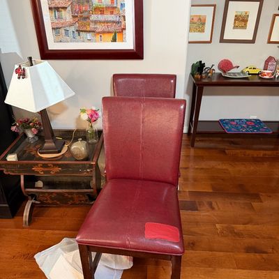 Sale Photo Thumbnail #212: Pair of contemporary high-back bar stools upholstered in burgundy faux leather, showing some wear and a patch on the front seat.