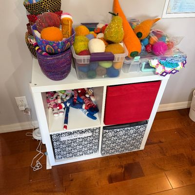 Sale Photo Thumbnail #63: White four-cube storage organizer filled with crafting supplies, including felted wool balls, fabric bowls, and storage bins.