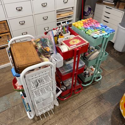 Sale Photo Thumbnail #46: Three rolling utility carts in white, red, and mint green, filled with various craft supplies including acrylic paints, beads, and sewing notions.