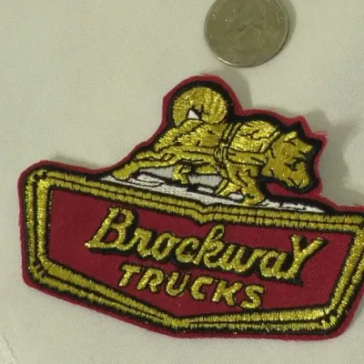 Vintage Brockway Trucks embroidered patch featuring the brand's signature husky dog logo in gold thread on a red background.
