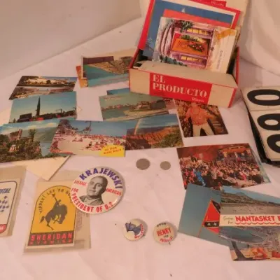 Collection of vintage ephemera, including mid-century travel postcards, political campaign buttons, a spiral-bound flip number sign, and...