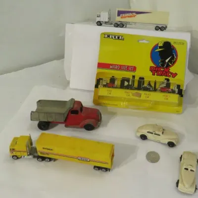 Collection of vintage toy vehicles, including an Ertl Dick Tracy micro size set in its original packaging, a yellow Ryder semi-truck, and...