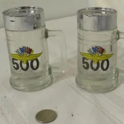 Vintage Indianapolis 500 glass salt and pepper shakers shaped like beer mugs with chrome-finished metal tops.