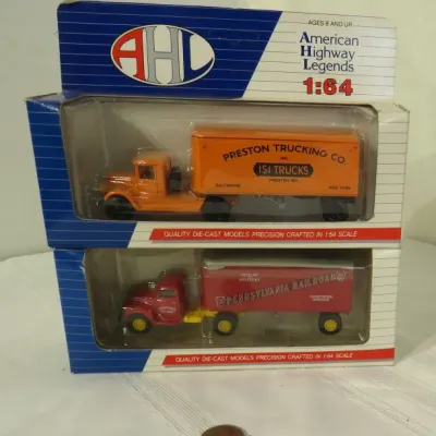 Two American Highway Legends 1:64 scale die-cast model semi-trucks in their original packaging, featuring a Preston Trucking Co. model...