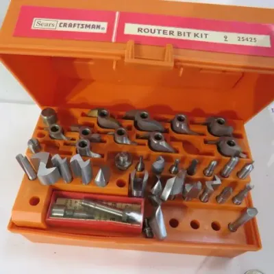 Vintage Sears Craftsman router bit kit, model 25425, in its original orange plastic storage case with an assortment of steel bits.