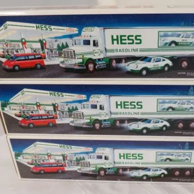 Stack of three vintage Hess toy truck boxes, featuring the 1993 Hess Patrol Car and Helicopter set in original packaging.