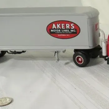 First Gear 1/64 scale die-cast Mack B-61 tractor with Fruehauf trailer, featuring Akers Motor Lines, Inc. livery in red, black, and silver.