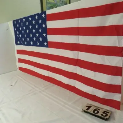 Large 50-star American flag in clean condition, displayed on a table.