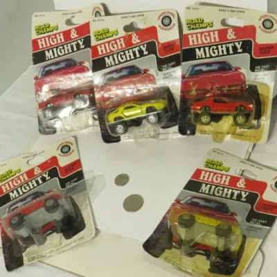 Five vintage Road Champs High & Mighty die-cast metal toy cars, still sealed in their original blister packs, circa 1980s.